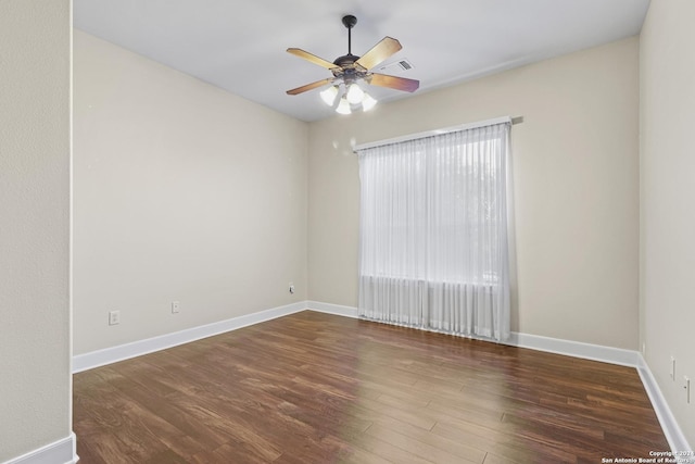 unfurnished room with dark hardwood / wood-style floors and ceiling fan