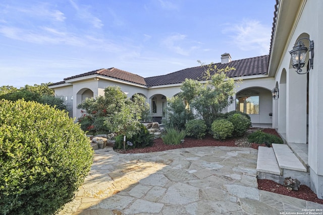 mediterranean / spanish home with a patio area