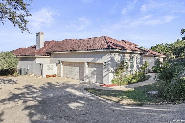 view of home's exterior featuring a garage and central AC