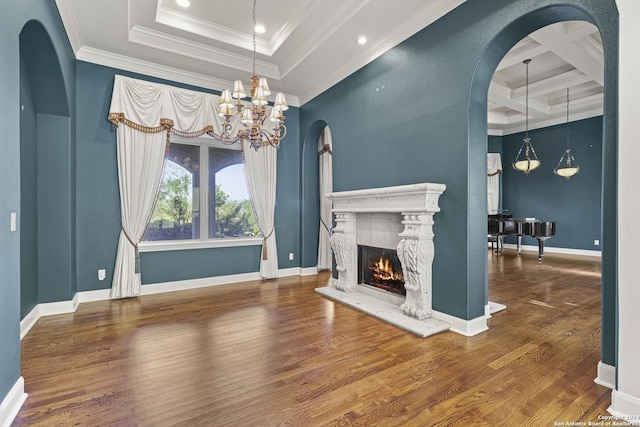 living room with coffered ceiling, crown molding, dark wood-type flooring, and a chandelier