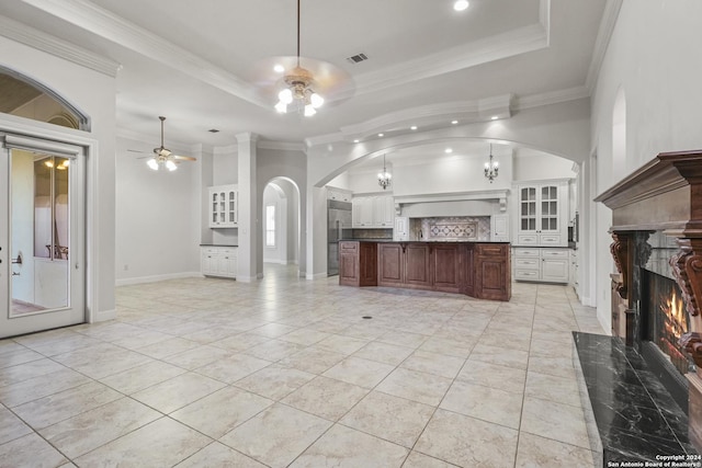 kitchen featuring a high end fireplace, ceiling fan with notable chandelier, crown molding, and stainless steel built in refrigerator