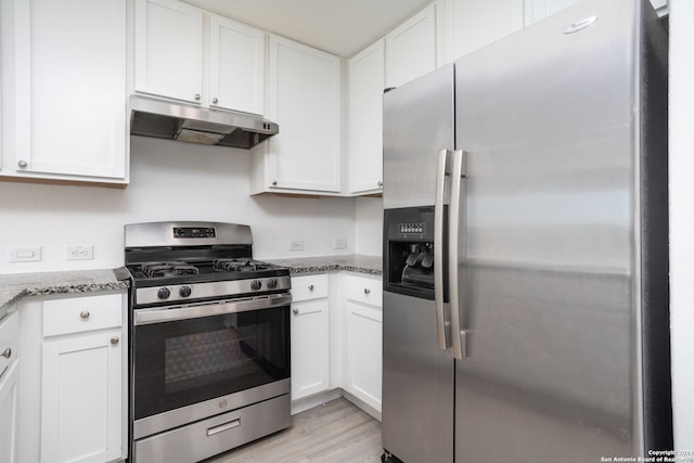 kitchen featuring white cabinets, stone countertops, light hardwood / wood-style floors, and appliances with stainless steel finishes