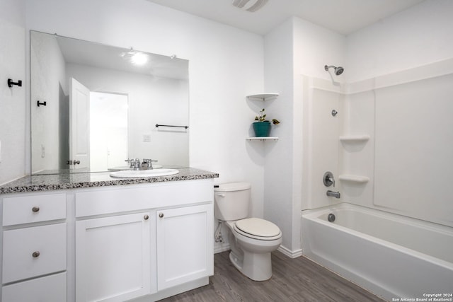 full bathroom with hardwood / wood-style floors, vanity, toilet, and bathing tub / shower combination