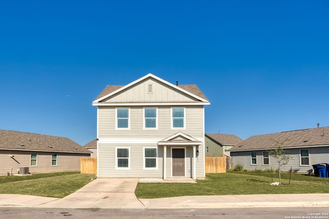 view of front of property with a front lawn and cooling unit