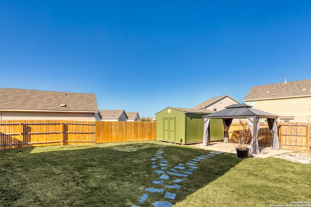 view of yard with a gazebo and a storage shed