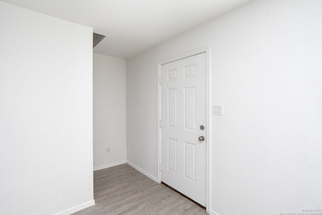 hall with light hardwood / wood-style floors