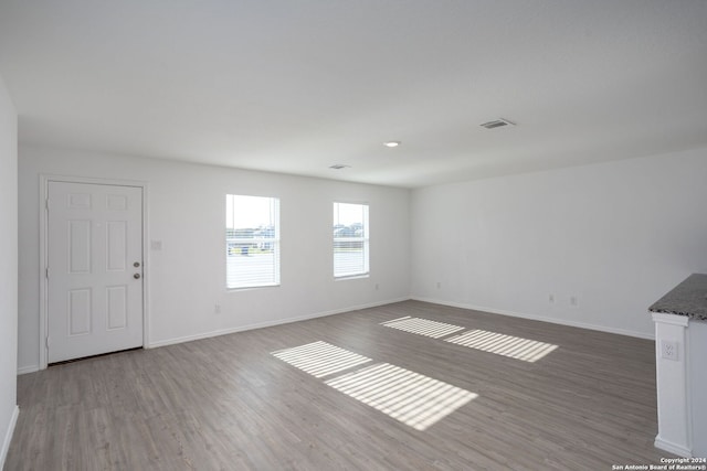 unfurnished living room featuring hardwood / wood-style floors