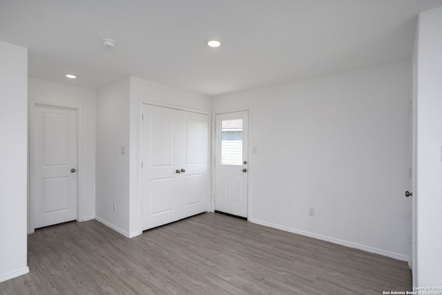 unfurnished bedroom with hardwood / wood-style flooring and a closet