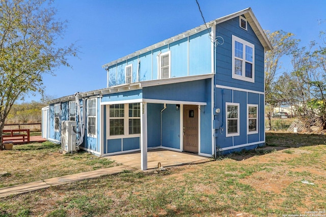 rear view of property featuring a patio