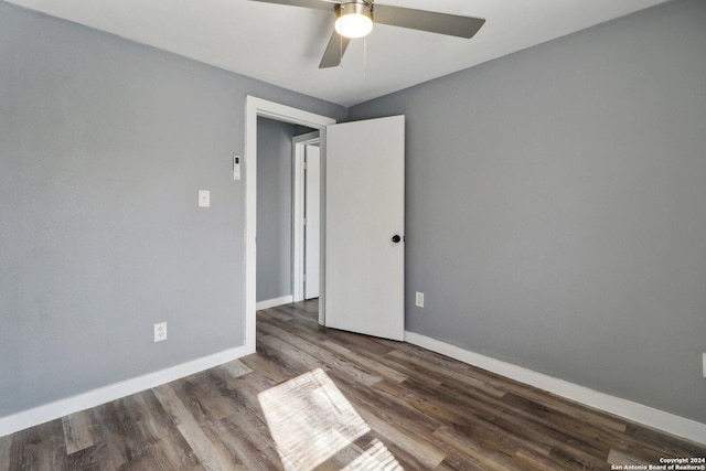 spare room featuring dark hardwood / wood-style floors and ceiling fan