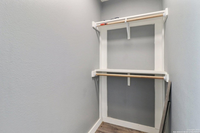 walk in closet with wood-type flooring