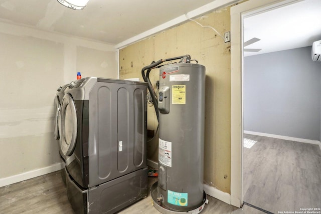 utilities with washing machine and dryer, electric water heater, and a wall unit AC