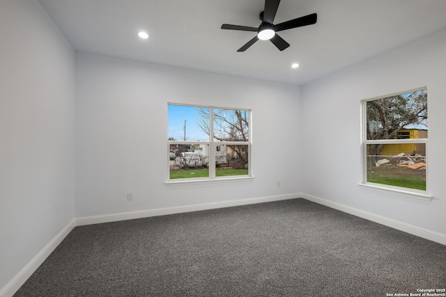 carpeted spare room featuring ceiling fan