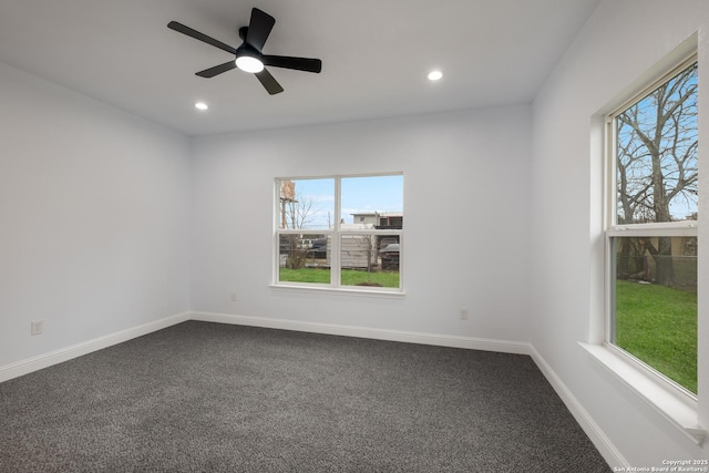 empty room with plenty of natural light, carpet floors, and ceiling fan