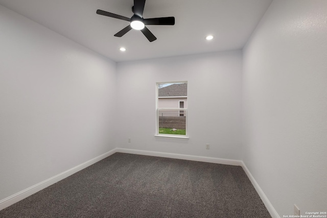 unfurnished room with ceiling fan and carpet