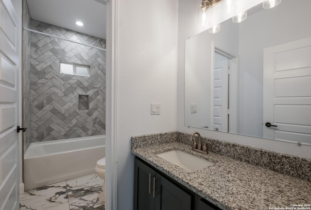 full bathroom with vanity, tiled shower / bath, and toilet