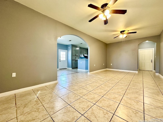 tiled empty room featuring ceiling fan