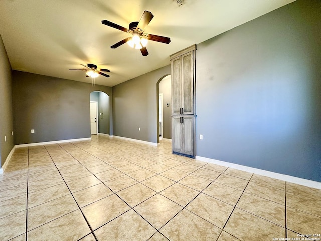 empty room featuring ceiling fan and light tile patterned floors