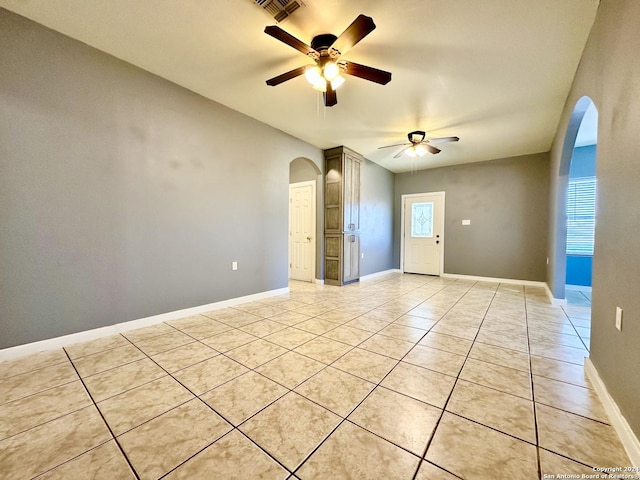 tiled empty room with ceiling fan