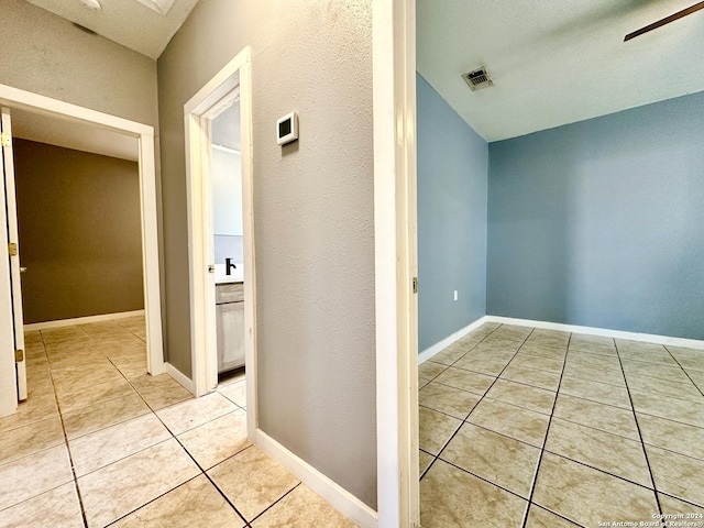 corridor featuring light tile patterned floors