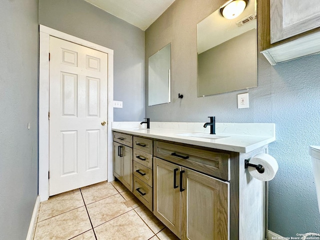 bathroom with tile patterned flooring and vanity