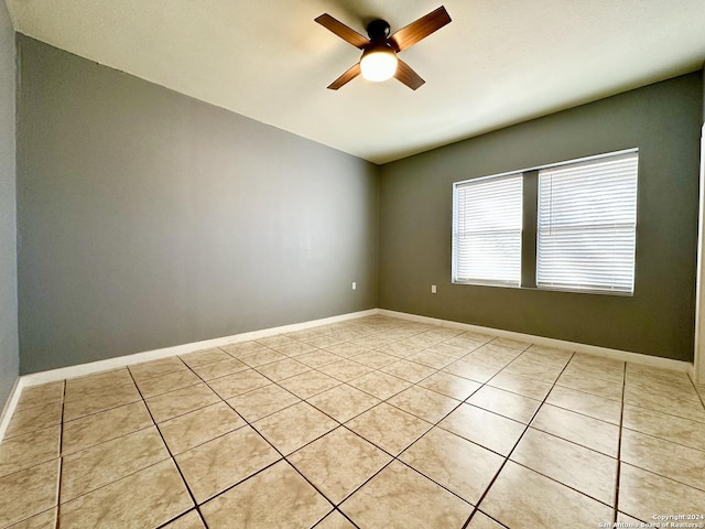 tiled empty room with ceiling fan