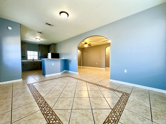 kitchen with ceiling fan, light tile patterned floors, sink, and fridge