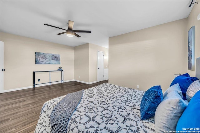 bedroom with dark hardwood / wood-style flooring and ceiling fan