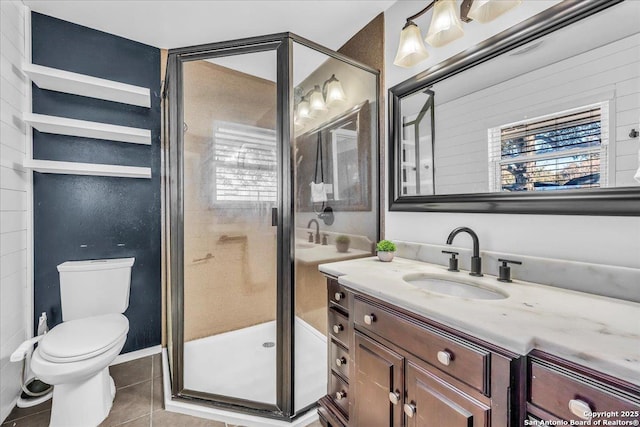 bathroom with an enclosed shower, a wealth of natural light, tile patterned floors, and toilet