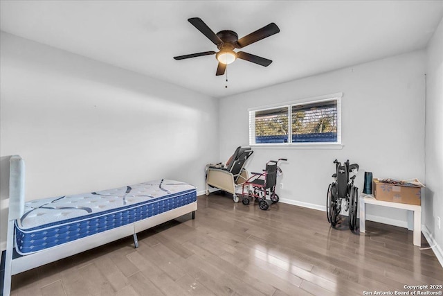 bedroom featuring hardwood / wood-style flooring and ceiling fan