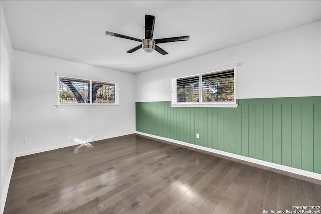 spare room with hardwood / wood-style flooring and ceiling fan