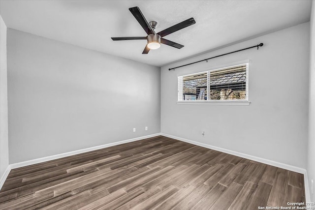 spare room featuring hardwood / wood-style floors and ceiling fan