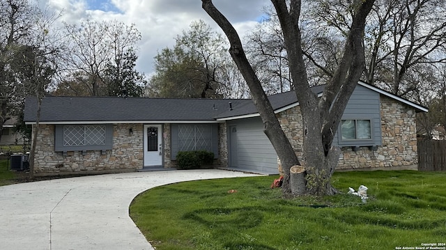 ranch-style house with a front lawn and central AC unit