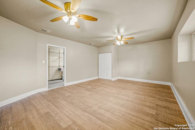 empty room featuring ceiling fan and light wood-type flooring