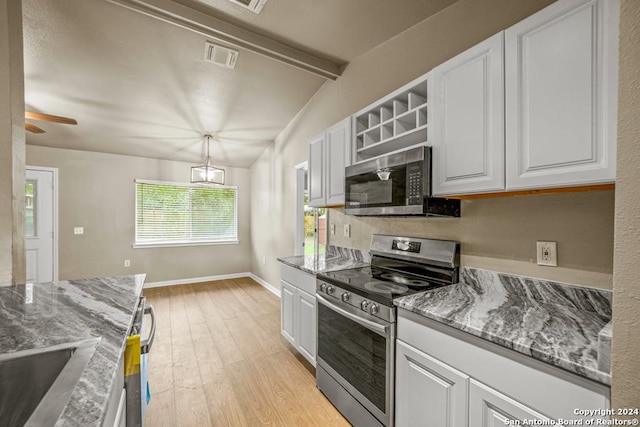 kitchen with appliances with stainless steel finishes, light wood-type flooring, light stone counters, decorative light fixtures, and white cabinets