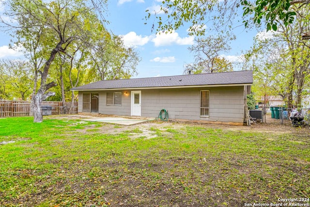 rear view of property featuring a yard