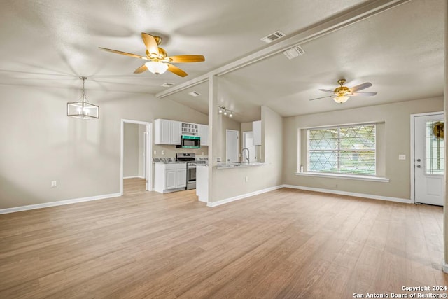 unfurnished living room with vaulted ceiling with beams, ceiling fan, sink, and light hardwood / wood-style flooring