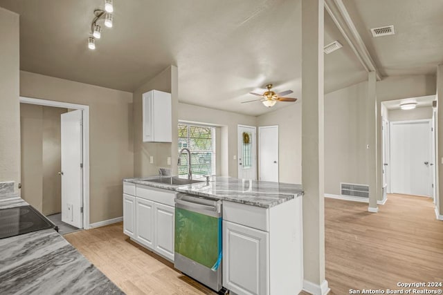 kitchen featuring lofted ceiling with beams, white cabinetry, sink, and stainless steel dishwasher