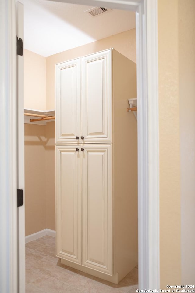 walk in closet featuring light tile patterned flooring