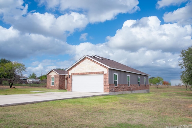 view of front of home with a front yard and a garage