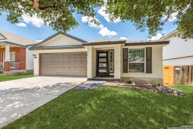 view of front of property with a front lawn and a garage