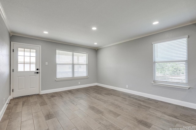 interior space with light wood-type flooring and ornamental molding