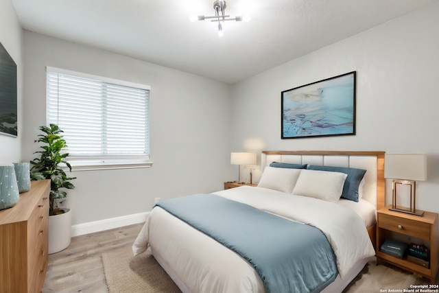 bedroom with light hardwood / wood-style floors