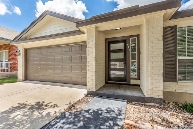 view of exterior entry with a garage