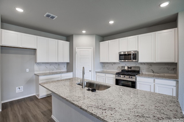 kitchen with backsplash, white cabinetry, sink, and appliances with stainless steel finishes