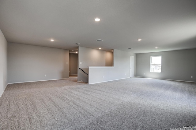 unfurnished room featuring light colored carpet