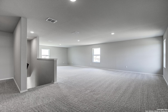 empty room with carpet flooring and plenty of natural light