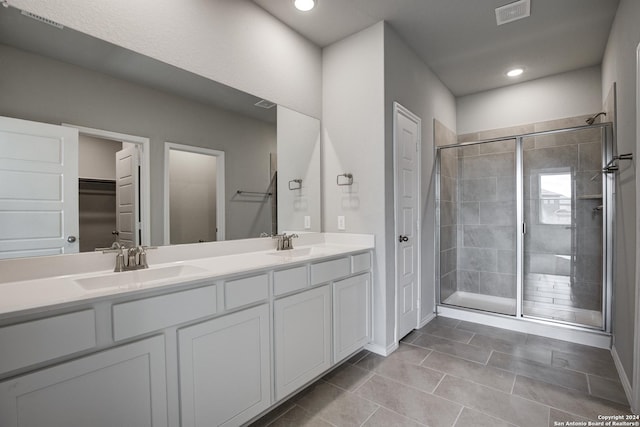 bathroom with tile patterned flooring, vanity, and an enclosed shower