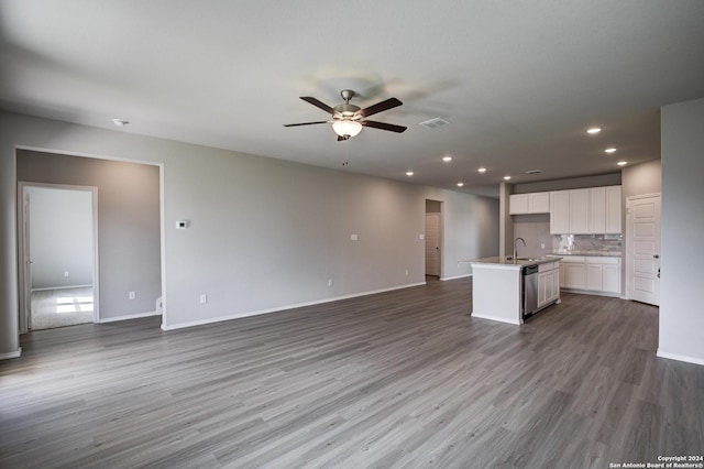 unfurnished living room with light wood-type flooring, ceiling fan, and sink