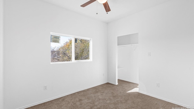 unfurnished room with carpet and ceiling fan